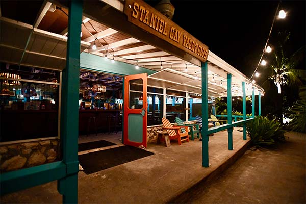 The outside of a restaurant in Staniel Cay is lit up at night.