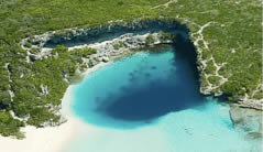 An aerial view of a charming blue hole in the sand, located in Staniel Cay, the stunning Bahamas.