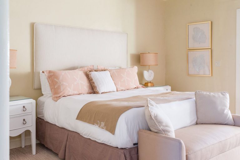 a-bedroom-with-a-beige-bed-and-a-white-dresser-perfect-for-relaxing-after-your-makers-air-flight-to-the-bahamas-768×512