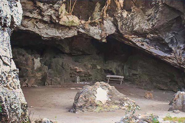 on-the-beautiful-chub-cay-there-is-a-serene-cave-adorned-with-a-bench-in-its-midst.-explore-this-hidden-gem-by-booking-a-flight-to-the-bahamas-with-makers-air