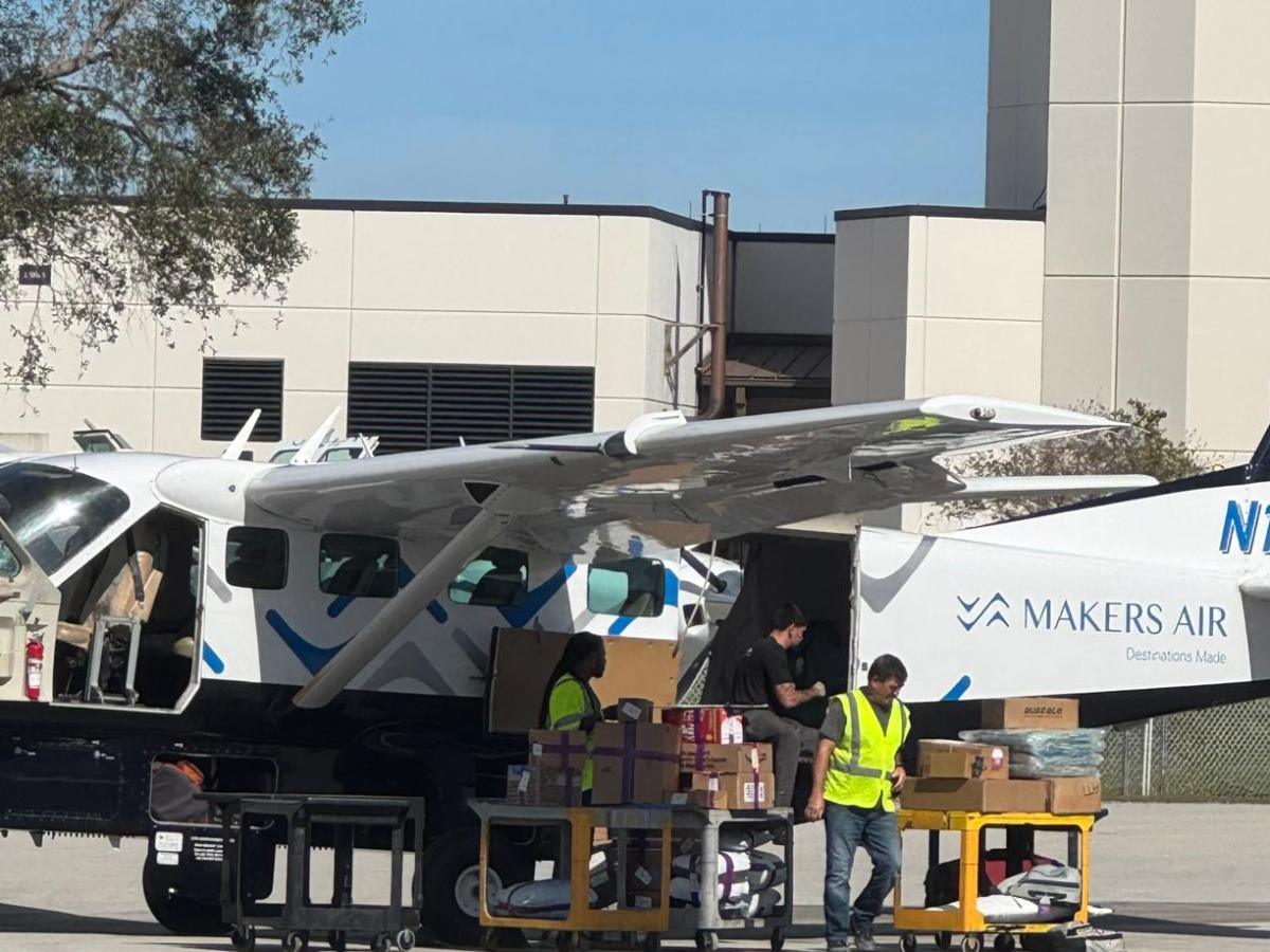 Cargo being loaded onto a small airplane at an airport.